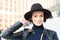 Skincare, youth, visage. Woman in black hat smile on stairs in paris, france, fashion. Beauty, look, makeup. Fashion, accessory, s