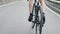 Skinny fit cyclist legs with strong muscles pedaling uphill out of the saddle. Cycling training uphill. Cycling concept. Slow moti