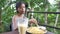 A Skinny young Asian woman eating fries and drinking sweet cold fruitshake