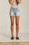 A Skirt in Blues Denim, Shorts feature a high waist, with a longer rise, relaxed leg with frayed hems, and classic five-pocket