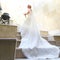 Skirt and veil lie on the footsteps while bride goes upstairs