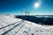 Skis are in deep snow on the ski track in sunny bright light