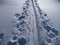 Skitouring trail in white snow covered mountains