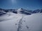 Skitouring trail in white snow covered mountains