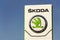 Skoda Auto automobile manufacturer from Volkswagen Group company logo in front of dealership building