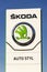 Skoda Auto automobile manufacturer from Volkswagen Group company logo in front of dealership building