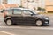 Skoda Roomster compact popular car on the city highway, side view. Brown family mpv driving on the street