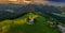 Skofja Loka, Slovenia - Aerial panoramic view of the beautiful hilltop church of Sveti Tomaz Saint Thomas with amazing sunset