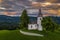 Skofja Loka, Slovenia - Aerial view of the beautiful hilltop church of Sveti Tomaz Saint Thomas with an amazing colorful sunset