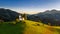 Skofja Loka, Slovenia - Aerial view of the beautiful hilltop Sveti Tomaz Saint Thomas church with a warm summer sunset