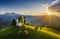 Skofja Loka, Slovenia - Aerial view of the beautiful hilltop Sveti Tomaz Saint Thomas church with a warm summer sunset