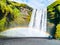 Skogafoss - one of the most beautiful waterfalls on sunny day with rainbow, Skogar, Iceland