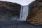 Skogafoss Waterfall In Iceland. Long Exposure Water Spray and Rocks.