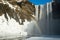 Skogafoss waterfall with snow and rainbow at winter, Iceland