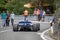 Skradin Croatia, June 2020 Back view of a blue formula race car, descending from the hill while people are walking by