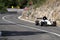 Skradin Croatia, June 2020 Green and black formula racecar seen from distance entering a corner going uphill during a race