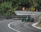 Skradin Croatia, June 2020 Green and black formula racecar seen from distance going uphill during a race championship