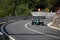 Skradin Croatia, June 2020 Green and black formula racecar seen from distance going uphill during a race championship