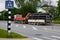 Skrunda, Latvia - Juny 16, 2022: The truck stopped in the city with many black, long plastic culverts in trailer