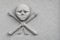 Skull and crossed bones carved on an new stone