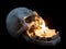Skull near lighting candle on dark background