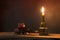 Skulls in the blood glass and candle on wooden table in candlelight