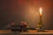 Skulls in the blood glass and candle on wooden table in candlelight