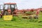 Skutech, Czech Republic, 4 June 2020: A small tractor with a rotary rake rakes freshly cut grass in the field