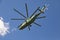 In the sky against white cloud is flying the largest and most load-lifting helicopter in the world 26 Halo painted in camo, t