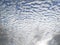 Sky background with cirrocumulus. Texture of white clouds, rounded like cotton flakes. Stormy skies in the French West Indies.