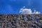 Sky and barbed wire on a stone fence