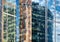 Sky and buildings are reflected in the office skyscraper facade