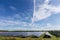 Sky with cirrus clouds over ground-mounted solar power station