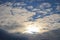 A sky with cirrus clouds, stratocumulus clouds and the sun