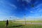 Sky, cloud, field, grassland, meadow, wind, daytime, energy, grass, atmosphere, horizon, prairie, air, travel, street, light, kite