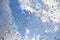 Sky and Clouds through large raindrops on window background