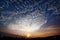 Sky, clouds, mountains, fields and dawn silhouettes.