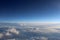 Sky and clouds photographed from the airplane window.