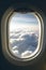 Sky with clouds seen through airplane window, created using generative ai technology