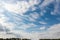 Sky with cumulus and cirrus clouds and contrail