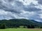 Sky with dark gray clouds over green Pohorje Mountains. Slovenia