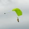 Sky diving tandem parachutists gliding toward landing