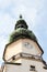 Sky, dome, clock and people on tower of Michael`s Gate on Michalska street