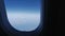 Sky and earth through the porthole of a flying airplane, background