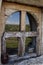 Sky and field landscape reflected in old wood window