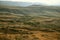 The sky in a haze and hilly valley, with autumn fields in the mountains of Gegham ridge