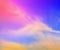 Sky midday sunlight beams rainbow pastel gradient pale orange-pink purple-blue dramatic. Beautiful sunny day soft light clouds