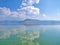 Sky mirroring  on  water at lake orestiada in Kastoria, Greece. Beautiful tranquil waterscape