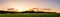 Sky panorama during sunset over forest with pastel colors sky and colorful clouds