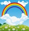 Sky with rainbow over green field with Daisies